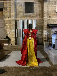 Costume for a Chinese goddess featuring sculptural faces of souls arranged along her spine. Costume design by Olya Chuk.