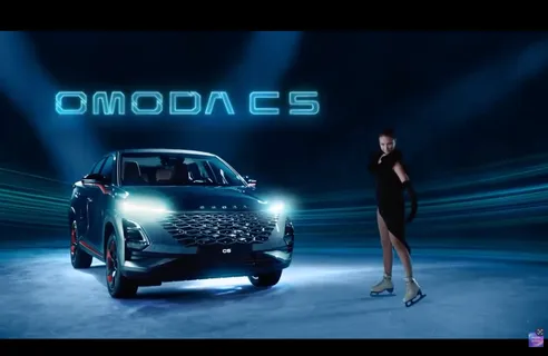 Olympic figure skater Anna Shcherbakova wearing a flexible custom dress designed for movement in an OMODA car commercial. Costume design by Olya Chuk.