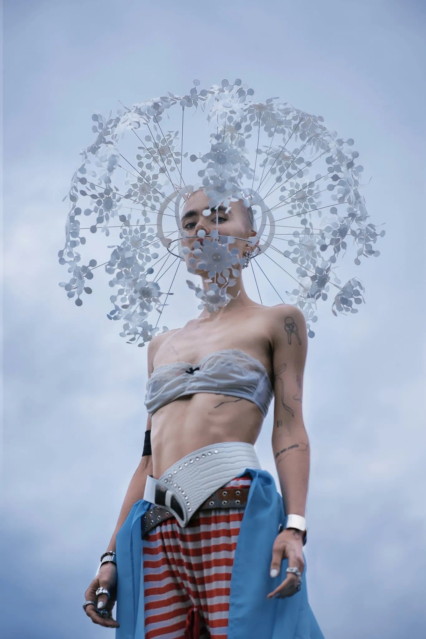 Model wearing a sculptural headpiece made by Olya Chuk and styled with garments found on the streets of Berlin.