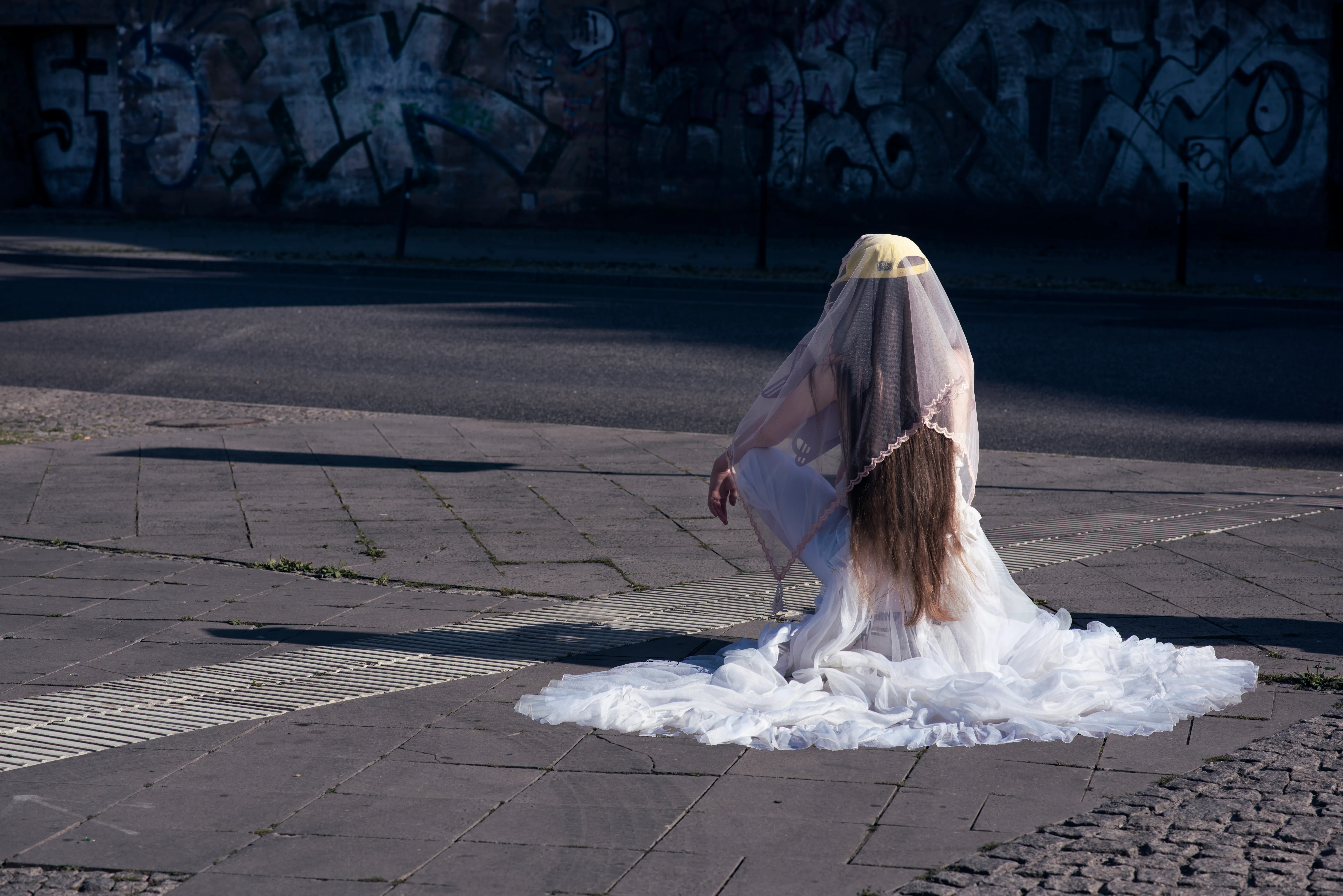 Model wearing a garment and veil made from discarded curtains found on the streets of Berlin, photographed on Warschauer Straße and styled by Olya Chuk.