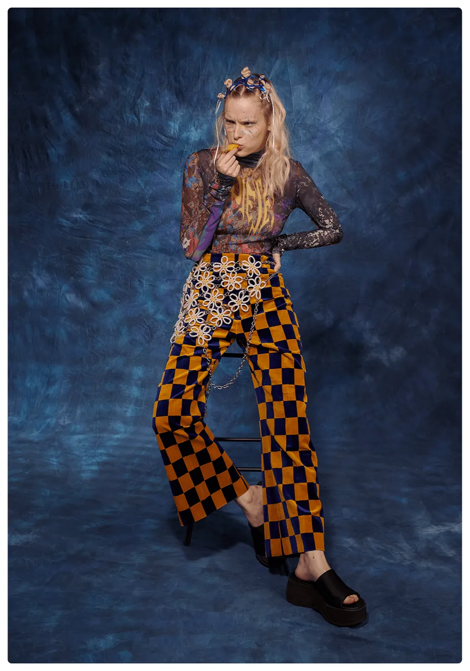 Young actress portrayed as the class weirdo in a school yearbook, wearing a clashing Diesel and Gucci look.