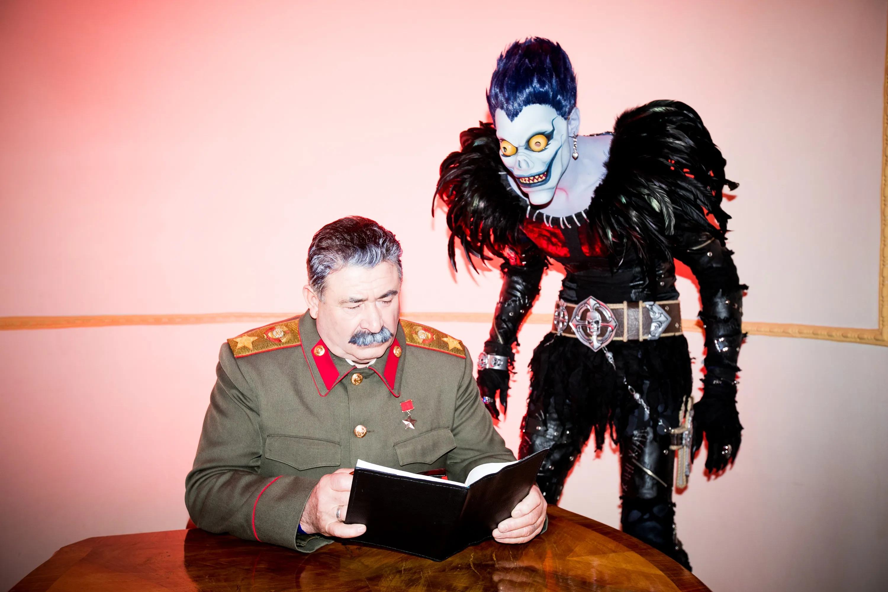 Immersive theatre scene featuring Stalin and Ryuk from Death Note in conversation, based on a surreal concept by Olya Chuk.