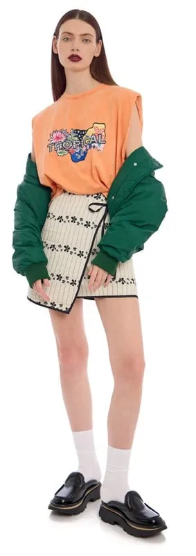 Model styled for Stockmann e-commerce in a playful summer look combining a graphic top, green jacket, printed skirt, and loafers. One of 120 multi-brand looks styled by Olya Chuk.