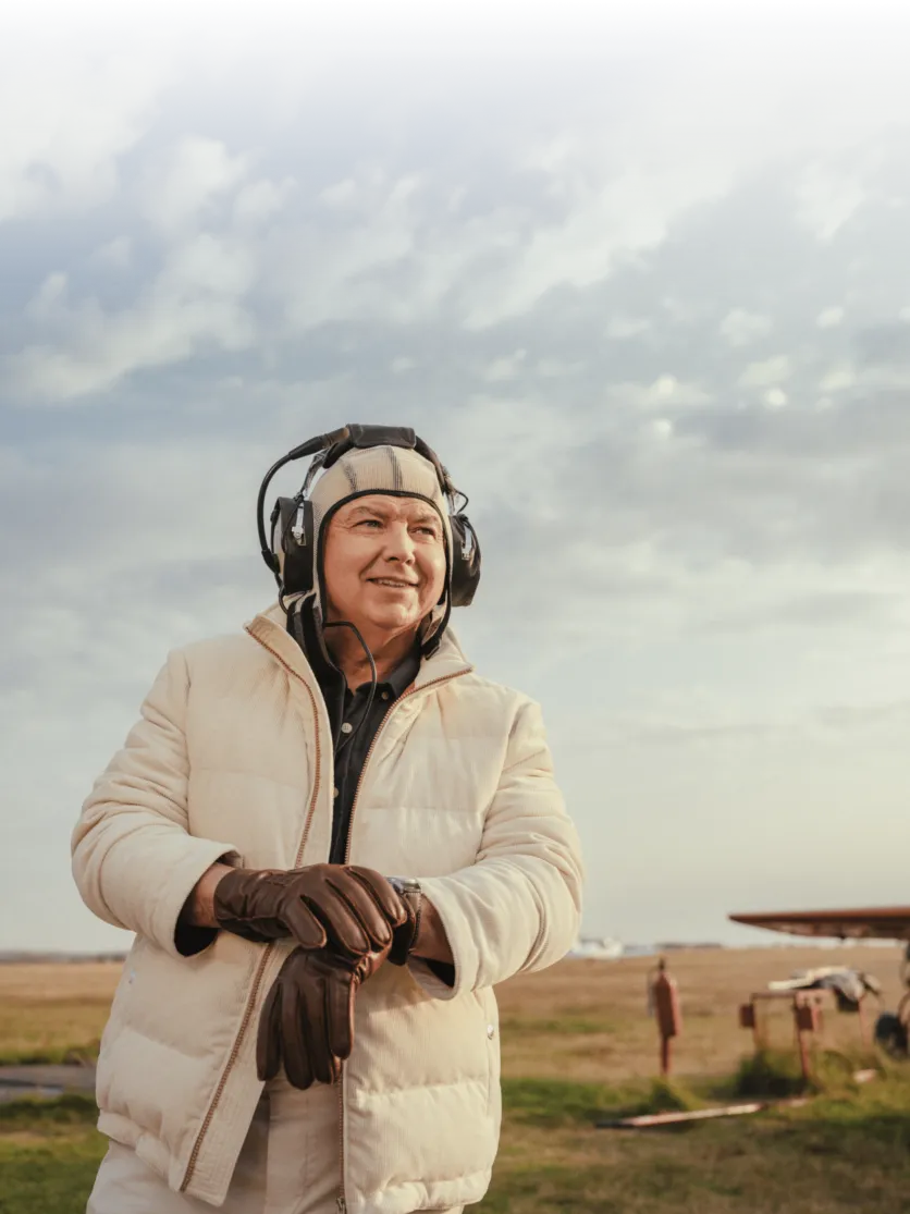 Real-life aviator photographed for a Longines × Esquire advertorial, wearing Brunello Cucinelli.